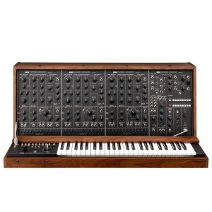 Front view of a vintage Korg PS-3300 polyphonic analog synthesizer, featuring three large panel sections filled with knobs, sliders, and patch cables, with a full 48-key keyboard beneath