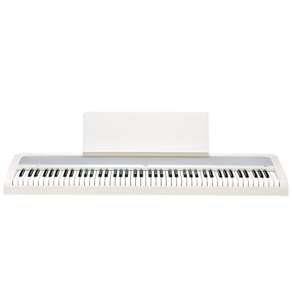 digital piano in black with a full 88-key weighted keyboard, matching stand, and three-pedal unit, shown in a modern home setting